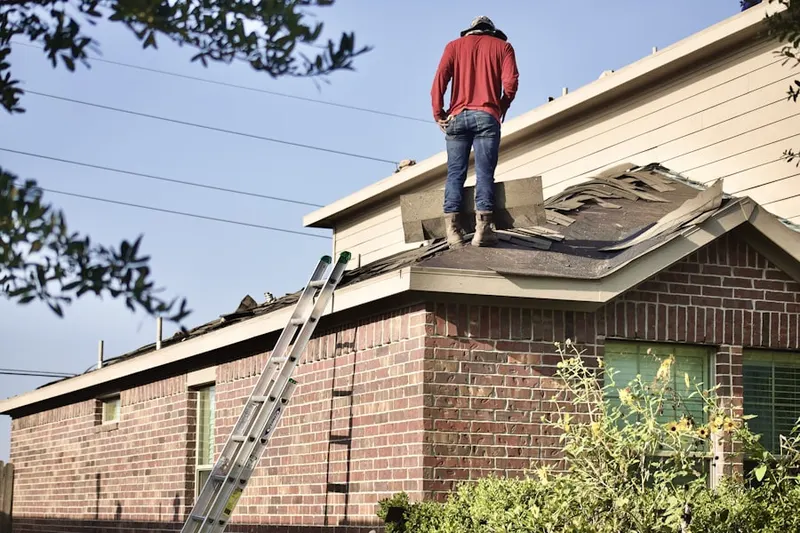 Professional roofer working on a residential roof in Rudgate East Company Mobile Home Park